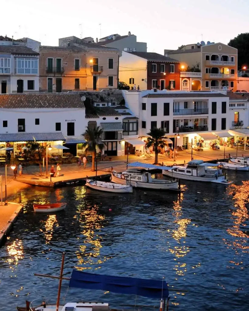 Charming waterfront homes and boats at sunset, evoking serene living in Sobha Siniyah Island.